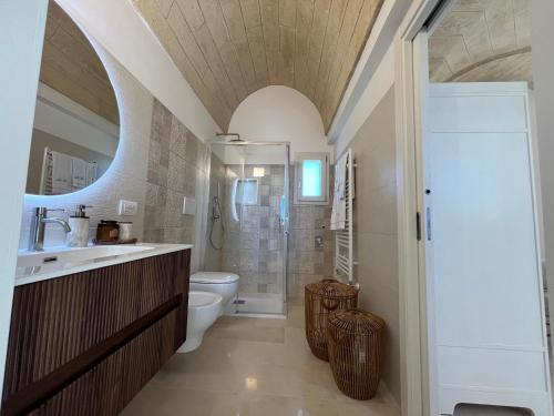 a bathroom with a toilet and a sink and a shower at Villa Chiara by salentoltremare in Corsano