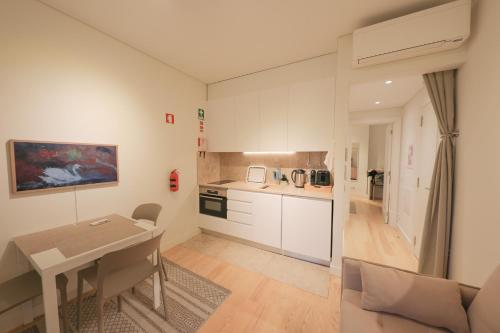 a kitchen with a table and a dining room at Ajuda Palace Inn Lisbon Apartments in Lisbon