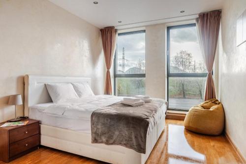 a bedroom with a bed and a large window at PhucAn Shared-Apartment in Riga in Riga
