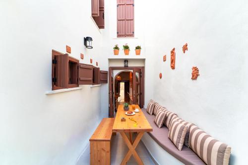 a dining room with a wooden table and chairs at Rodos Old Town Aqua Luxury House in Rhodes Town