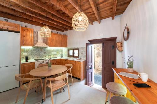 a kitchen with a table and chairs in a kitchen at Rodos Old Town Aqua Luxury House in Rhodes Town