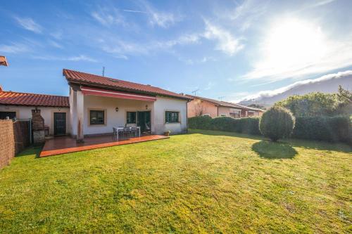 a backyard of a house with a grass yard at Your retreat on the Asturian coast in Andrín