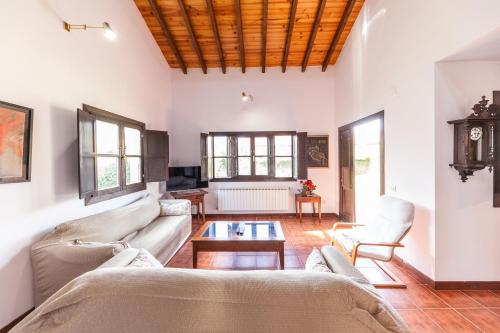 a living room with a couch and a table at Your retreat on the Asturian coast in Andrín