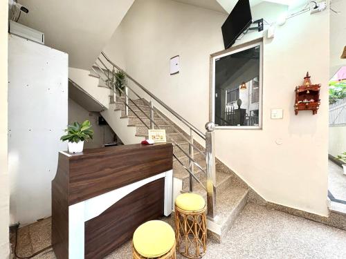 a staircase in a house with two stools at Zuna Stayz Tapovan Rishikesh in Rishīkesh