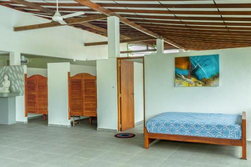 a bedroom with a bed and two wardrobes at Garden Villa Talalla in Talalla