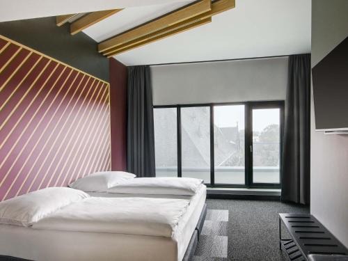 Ένα ή περισσότερα κρεβάτια σε δωμάτιο στο B&B HOTEL Zwickau