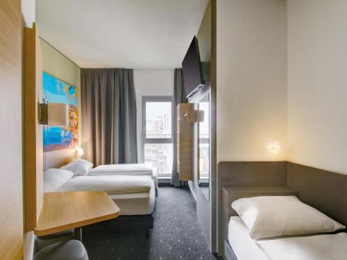 Ένα ή περισσότερα κρεβάτια σε δωμάτιο στο B&B HOTEL Zwickau