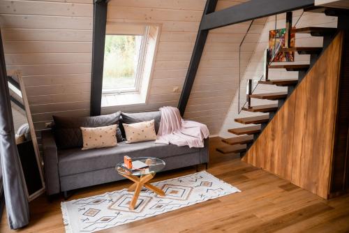 a living room with a couch and a staircase at Дім у Карпатах in Rechka