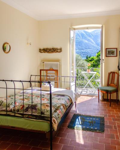 a bedroom with a bed and an open door at Villa dei Muralti- 2 free parkings in Muralto