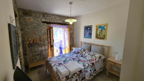 a bedroom with a bed and a window at A Casuzza in Caronia