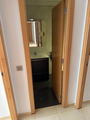 an open door to a bathroom with a sink at Y&To in Grao de Castellón