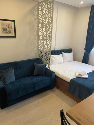 a room with a bed and a couch and a table at Milmari N53 in Kopaonik