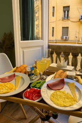 a table with plates of food on top at Hathor House in Cairo