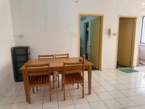 a dining room with a wooden table and chairs at Sweet home Beverly hills in Penampang