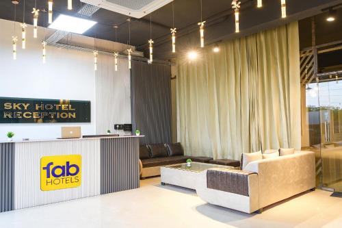 a living room with a couch and a table at FabHotel Sky I in Gurgaon
