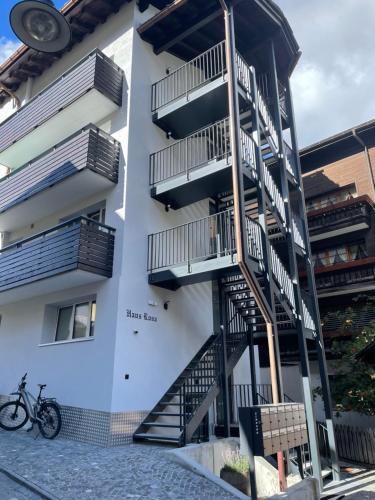 um edifício com escadas e uma bicicleta estacionada ao lado em Haus Rosa em Zermatt