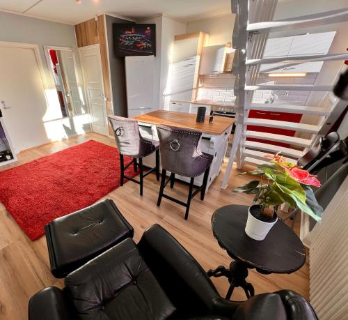 a living room with a dining room table and chairs at Centrally-located Unique Private apartment with 3 floors in Smedjebacken