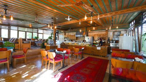 a restaurant with tables and chairs and a kitchen at Grand Elite Cave Suites in Goreme