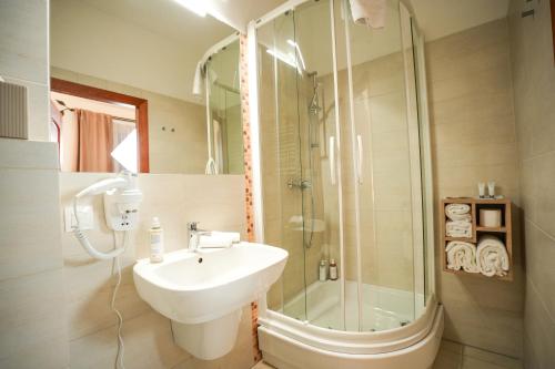 a bathroom with a sink and a shower at Villa Admiral in Gdynia
