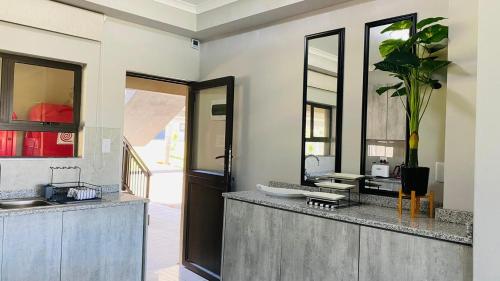 a bathroom with a sink and a mirror at Sun-Ash Sea Gardens in Port Shepstone