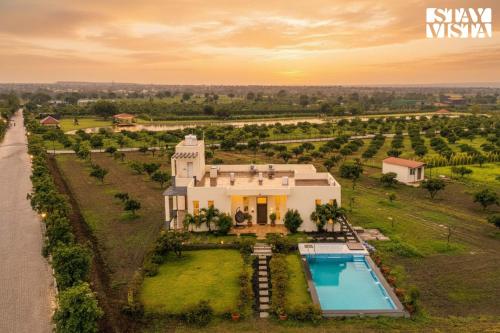 an aerial view of a house with a swimming pool at StayVista at Casa Shwika with Pool and Lawn in Hyderabad