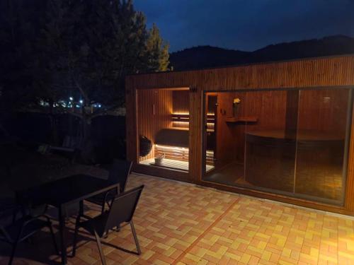 a large wooden house with a patio at night at Chata Triangel Komjatná in Komjatná