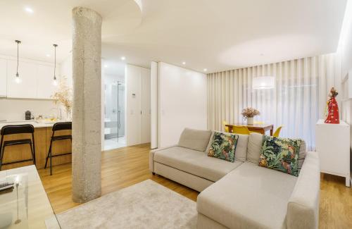a living room with a couch and a kitchen at Casa do Alcaide - Minhos Guest in Braga