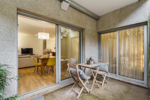 a living room with a table and chairs at Casa do Alcaide - Minhos Guest in Braga