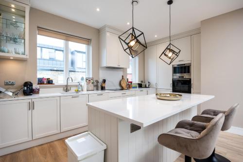 a kitchen with white cabinets and a white counter top at New 2-Bed Home with Garden Near Google Dublin HQ & Train Station in Dublin