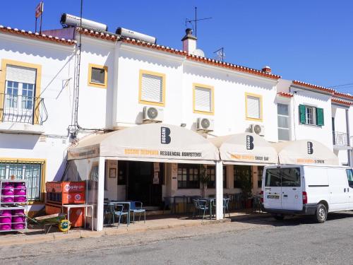 a white building with a van parked in front of it at Residencial Boavistense by Umbral in Odemira