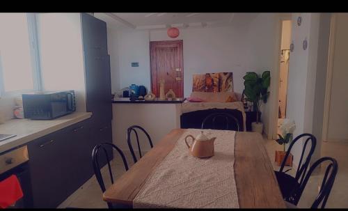 a kitchen with a table and chairs in a room at Sony in Kelibia
