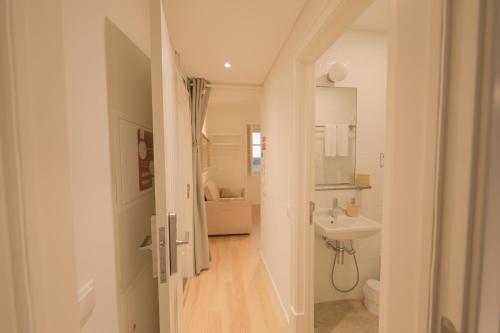 a white bathroom with a sink and a toilet at Ajuda Palace Inn Lisbon Apartments in Lisbon