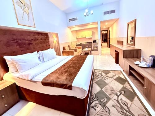 a bedroom with a large bed in a room at New Dream Plaza Hotel Apartment in Dubai