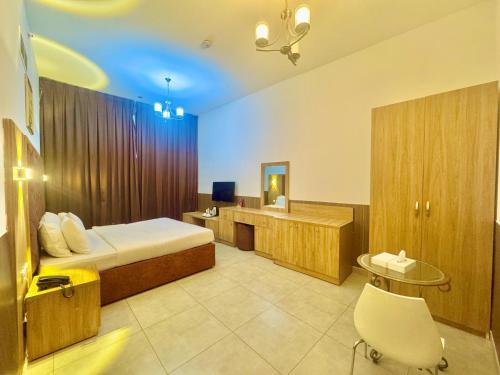 a hotel room with a bed and a bathroom at New Dream Plaza Hotel Apartment in Dubai
