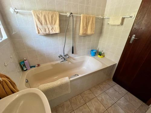 a bathroom with a bath tub and a toilet at SeaSalt Escape in Plettenberg Bay