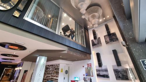 a person taking a picture in a store at Evenia Rocafort in Barcelona