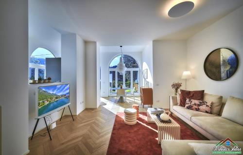 a living room with a couch and a flat screen tv at APT in Villa Bianca with Pool and air conditioning in Lierna