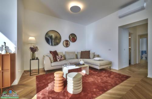 a living room with a couch and a table at APT in Villa Bianca with Pool and air conditioning in Lierna