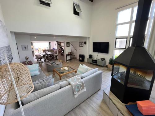 a living room with a couch and a fireplace at SeaSalt Escape in Plettenberg Bay