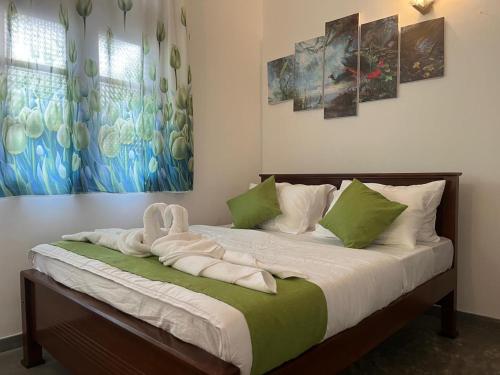 a bed with a towel on it in a bedroom at Villa J-95 in Galle