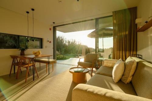 a living room with a couch and a table at oceanHUTS Coxos Adults Only in Ericeira