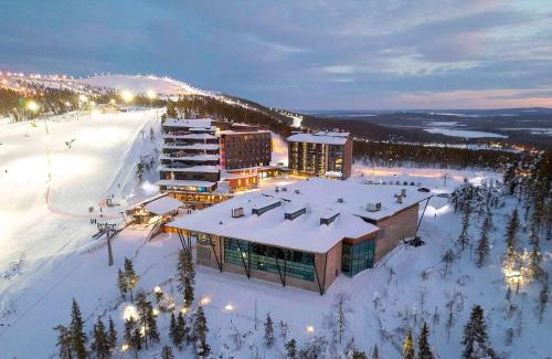 a ski resort in the snow at night at Hotel Levi Panorama in Levi