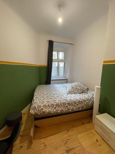 a small bedroom with a bed and a window at The Cozy Green in Berlin