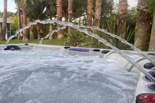 a pool with water shooting up into the air at Villa Summer Wind - Palm Beach Agathois in Le Grau-dʼAgde