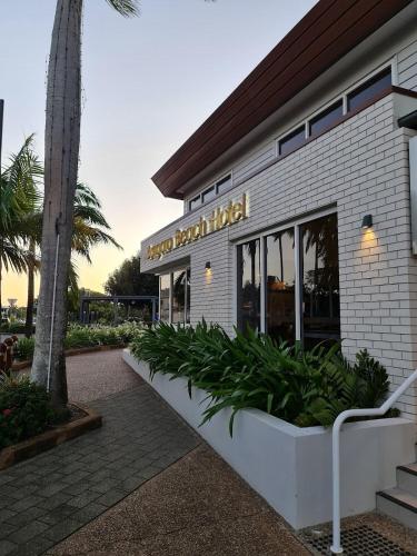 a restaurant with a sign on the side of a building at Seeside Cottage - Sleeps 6 & Pets in Bargara