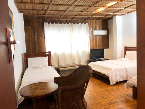 Ένα ή περισσότερα κρεβάτια σε δωμάτιο στο I vilainn Bukit Bintang