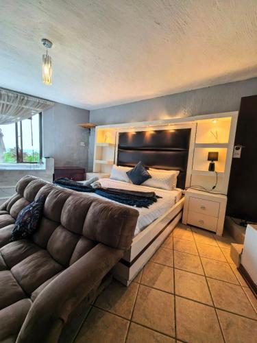 a bedroom with a large bed and a couch at Ui Views in Margate