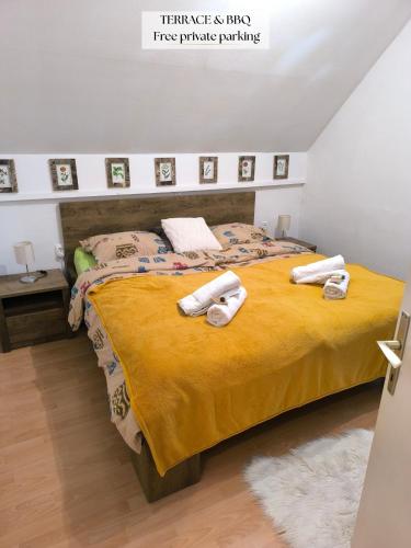a bedroom with a bed with towels on it at Apartma Dian in Mostec
