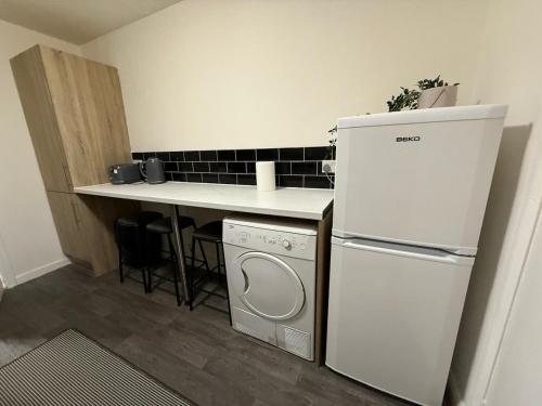 a kitchen with a washer and dryer next to a counter at A&A Luxury Stay Rosedale - 4 Bed Residence in Sunderland