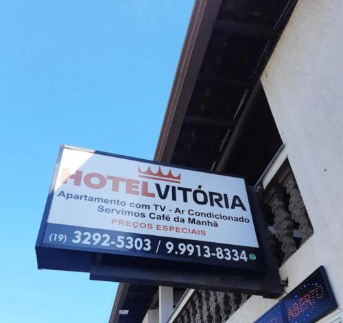 a sign for a hotel on the side of a building at Hotel vitoria in Pedreira